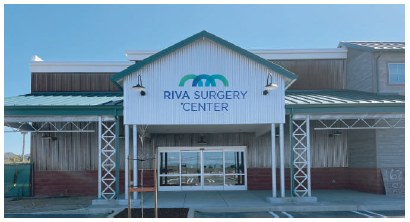 The RIVA Surgery Center entrance in Orcutt, California, with the illuminated sign above the doors